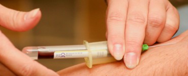 person injecting syringe