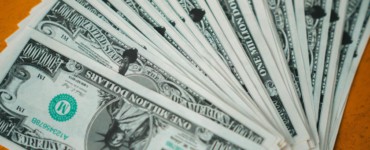 Closeup of novelty one million dollar bills laid out in a fan arrangement.