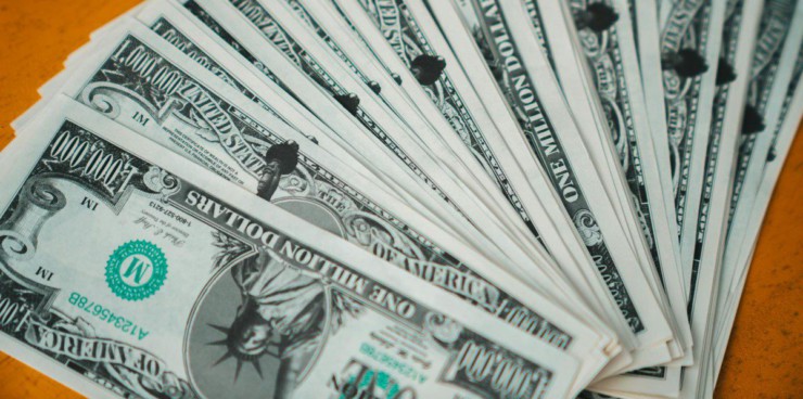 Closeup of novelty one million dollar bills laid out in a fan arrangement.