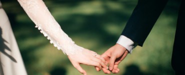 man and woman holding hands focus photo