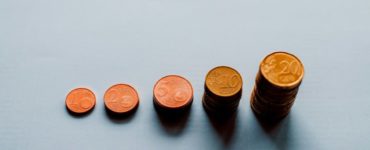 eight round gold coins on white surface