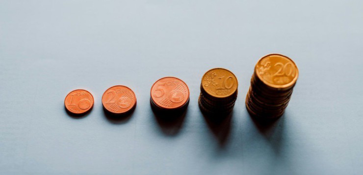 eight round gold coins on white surface