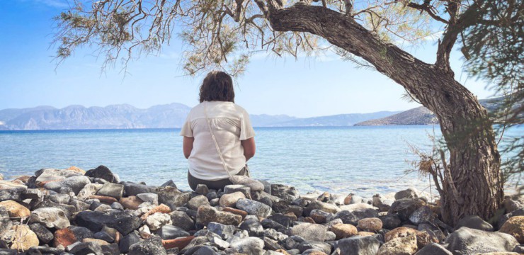 A person sits and enjoys the scenic seaside view.
