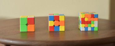 a wooden table topped with three different colored blocks