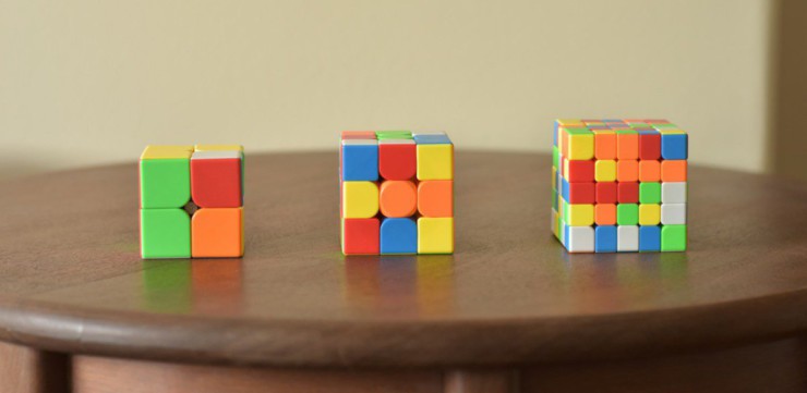 a wooden table topped with three different colored blocks