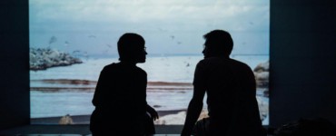 silhouette of man and woman sitting on ottoman