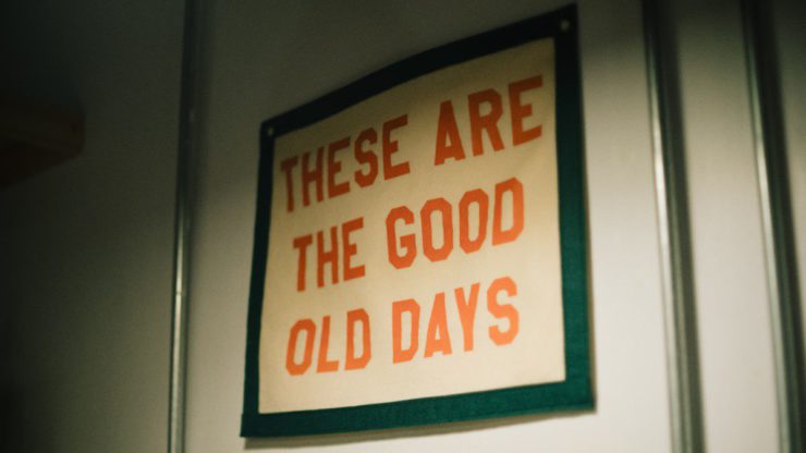 A sign hanging on a wall that says these are the good old days